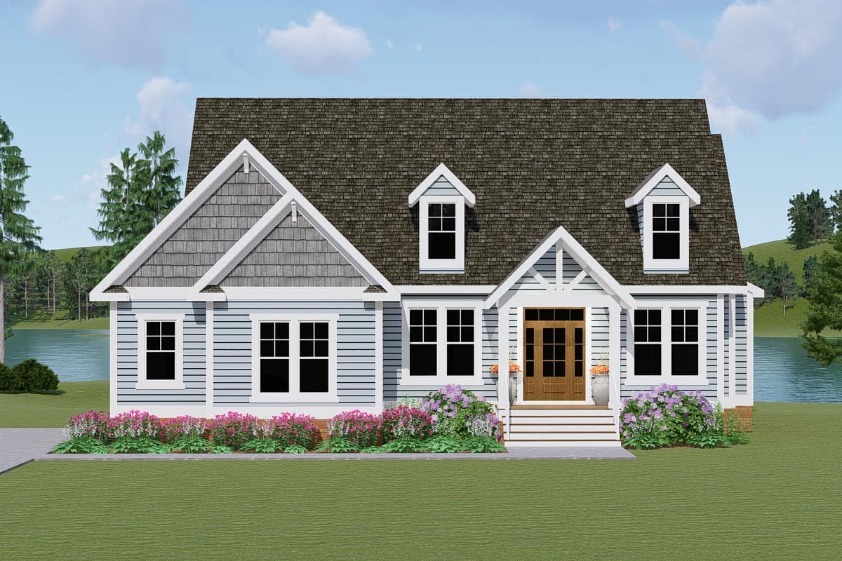 House plan exterior: Two-story dwelling with a gable roof, shingle siding accents, covered entry with double doors, and dormer windows.