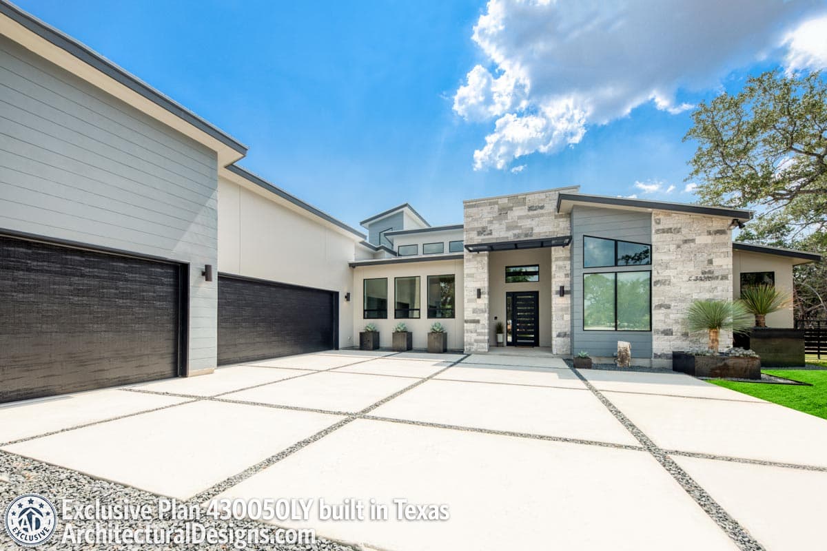 Modern house plan exterior with a three-car garage, stone and stucco facade, and multiple gables.
