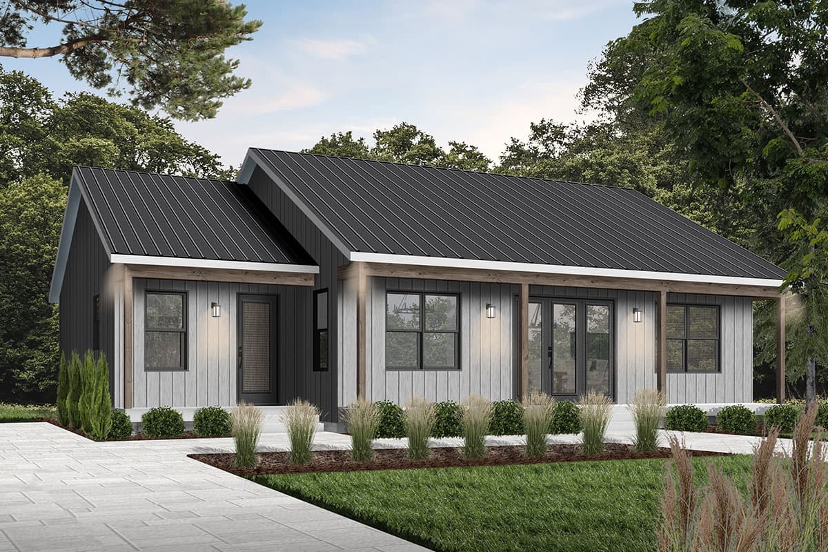 Modern, single-story house with a black metal roof, light gray siding, and a covered porch. Lush landscaping surrounds the home with a paved walkway.