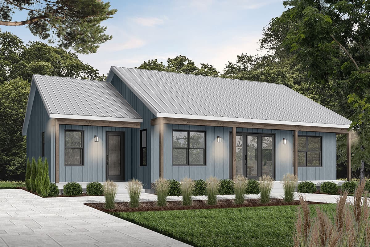 A modern, blue-sided house with a metal roof. It features large windows, a front porch, and is set against a backdrop of trees and a stone pathway.
