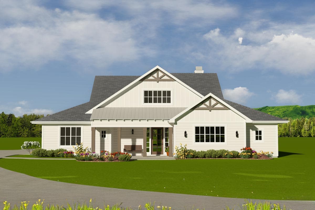 A white, modern farmhouse with a covered porch and bench, set against a green lawn and bright blue sky with a hint of landscape.