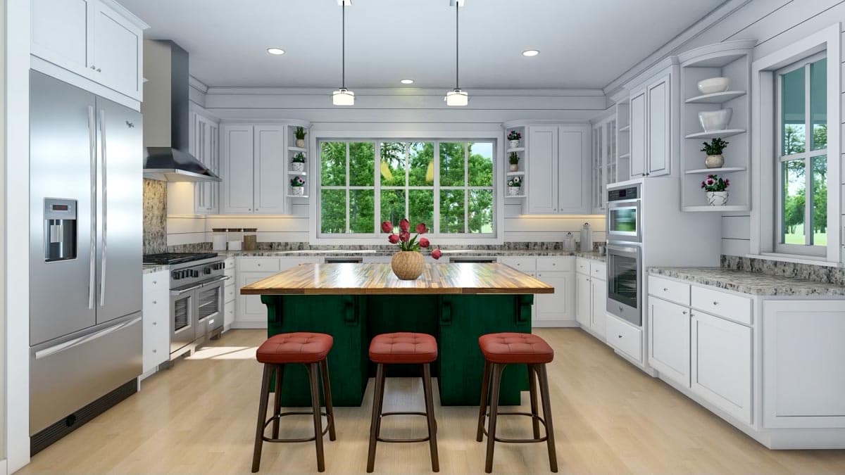 Spacious, modern kitchen with white cabinets, stainless steel appliances, and a green island with bar stools. A large window overlooks a wooded area.