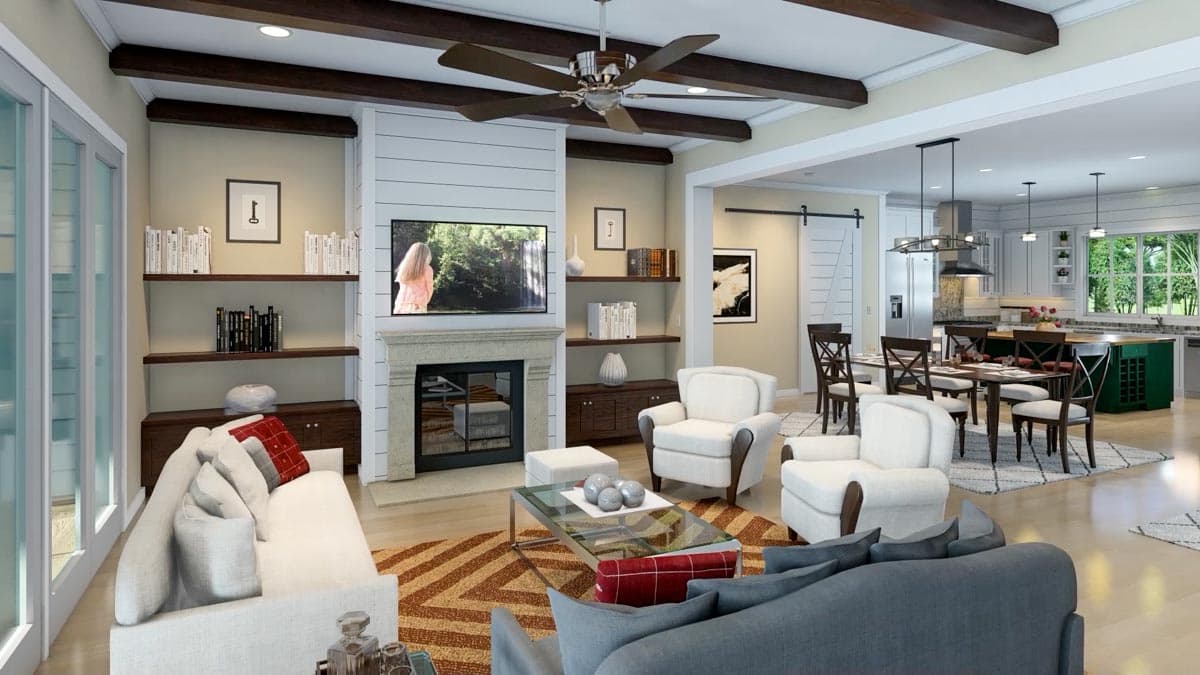 Spacious, open-concept living room featuring a fireplace, built-in shelving, comfortable seating, and a view into the dining area.