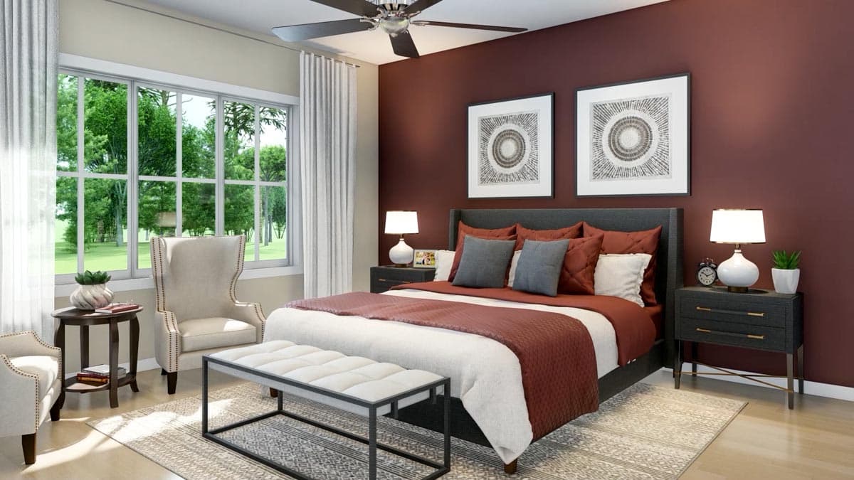 A modern bedroom with a large bed, decorative art, and a window with a view of greenery. The color scheme is deep red and gray.