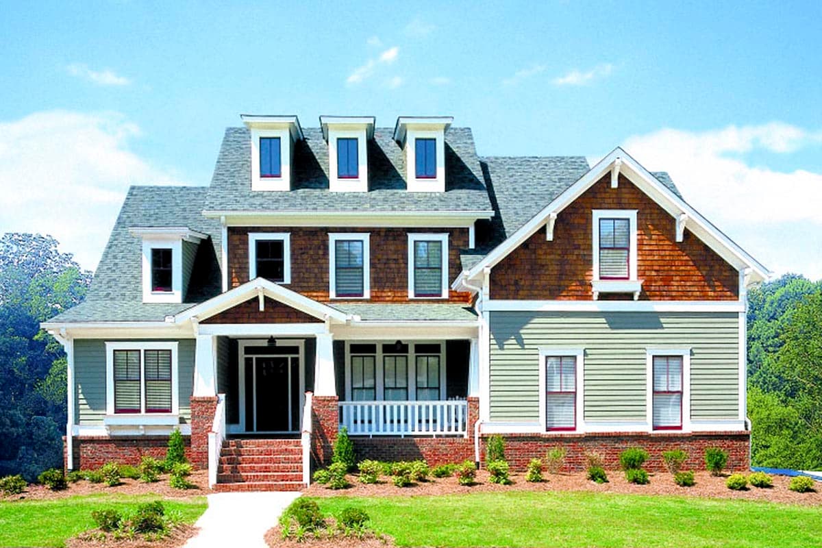 House plan exterior. Two-story Craftsman home with a front porch, gabled roof, and multiple dormers. Features wood siding and a brick facade.