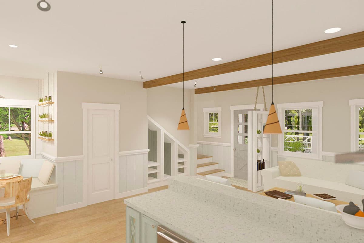 Open-concept interior with kitchen island, built-in banquette seating, and a staircase with storage. Exposed wood beams on ceiling.