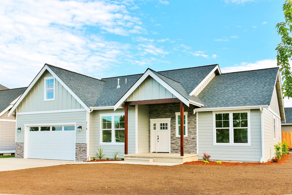 House plan exterior. Craftsman style with a gabled roof, covered entry porch, and attached garage. One story structure.