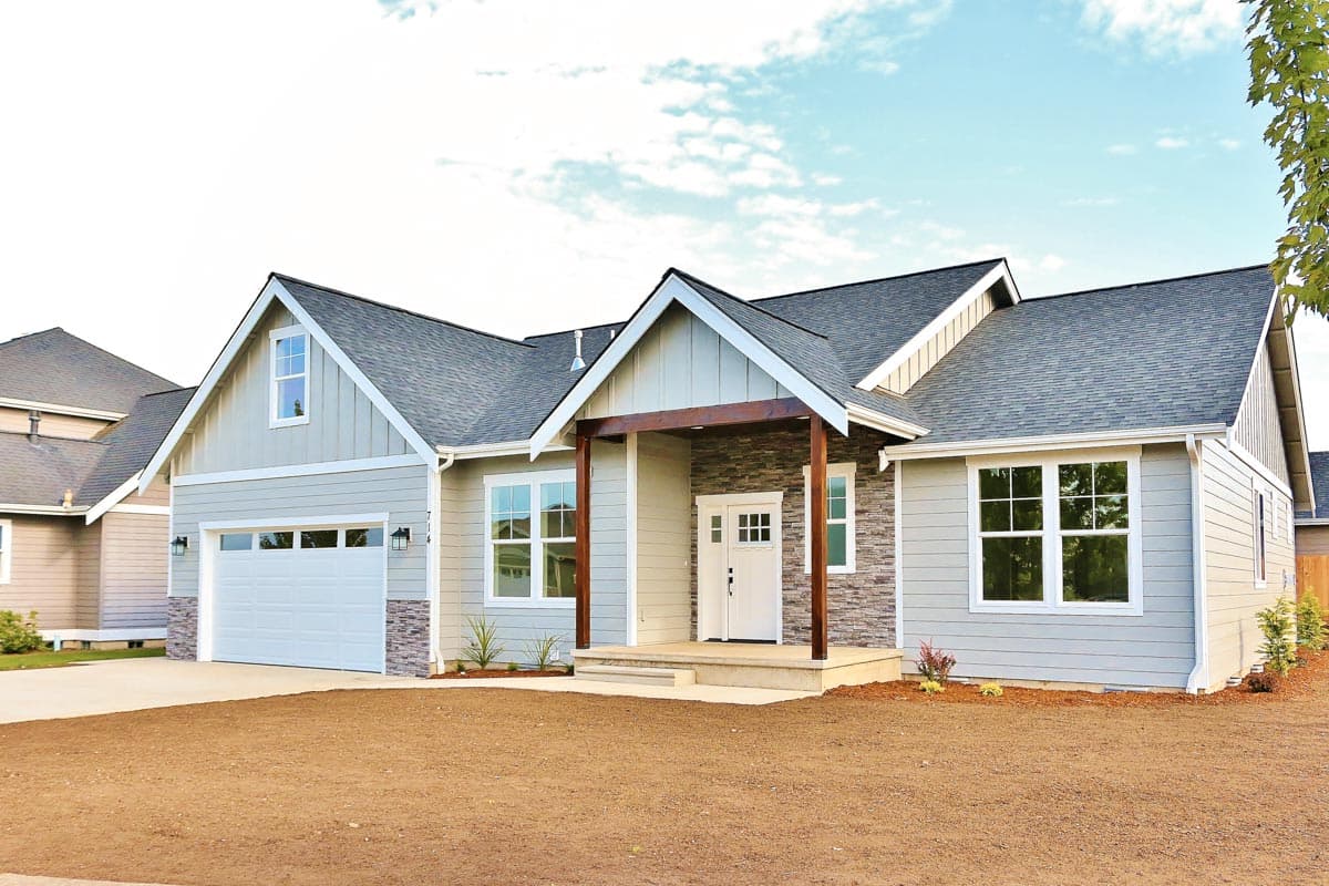 House plan exterior: single-story Modern Farmhouse with covered entry, stone accents, large windows, and attached garage.