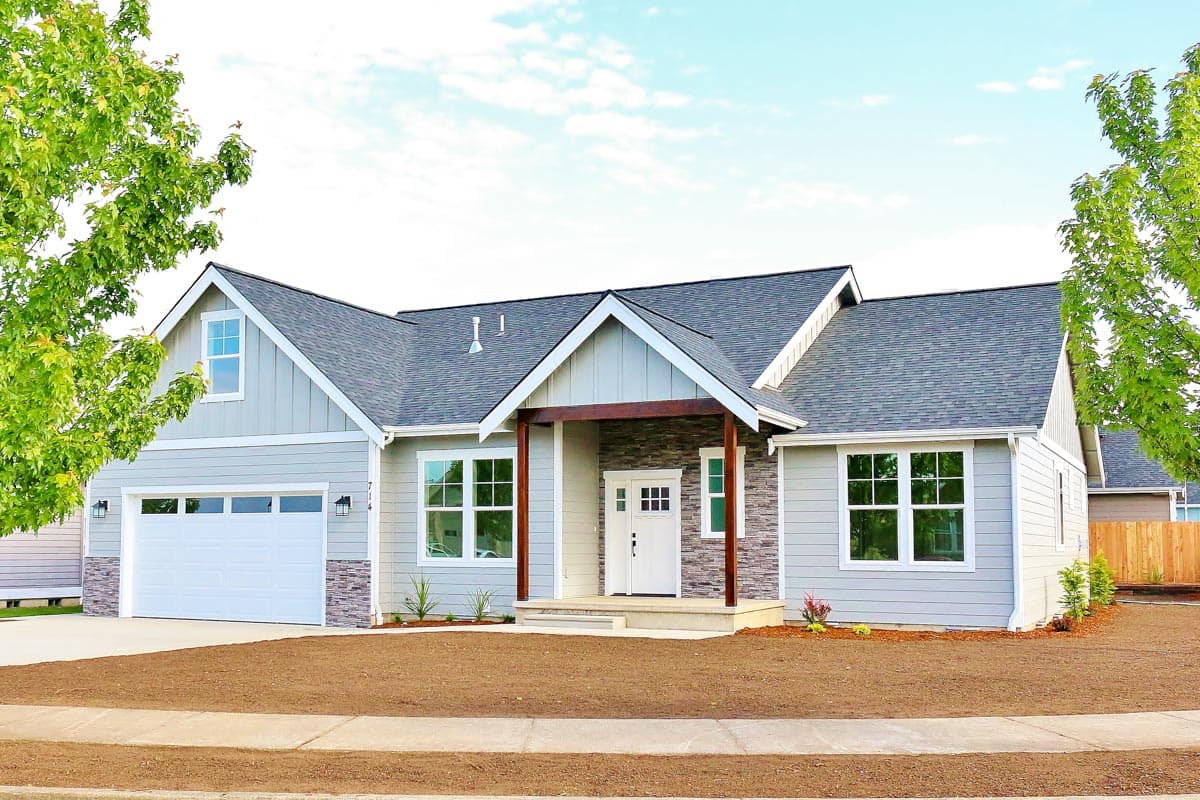 Modern Farmhouse style house plan exterior with a covered entry porch, multiple gables, a dormer window, and a two-car garage.