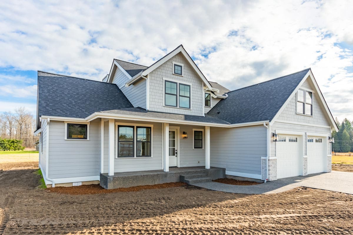 House plan exterior: Two-story Modern Farmhouse with a covered front porch, gabled dormers, and a three-car garage.