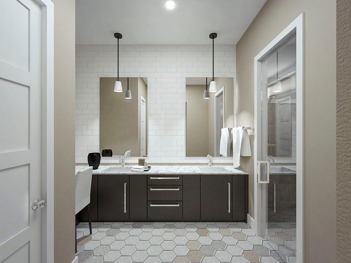 Bathroom with double vanity, subway tile backsplash, hexagonal floor tiles, and glass-enclosed shower.