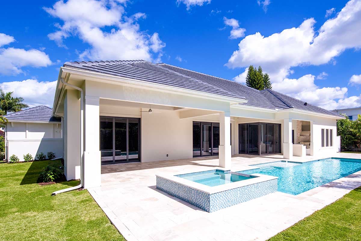 House plan exterior: Single-story Modern home with a tiled hip roof, covered patio, and swimming pool.