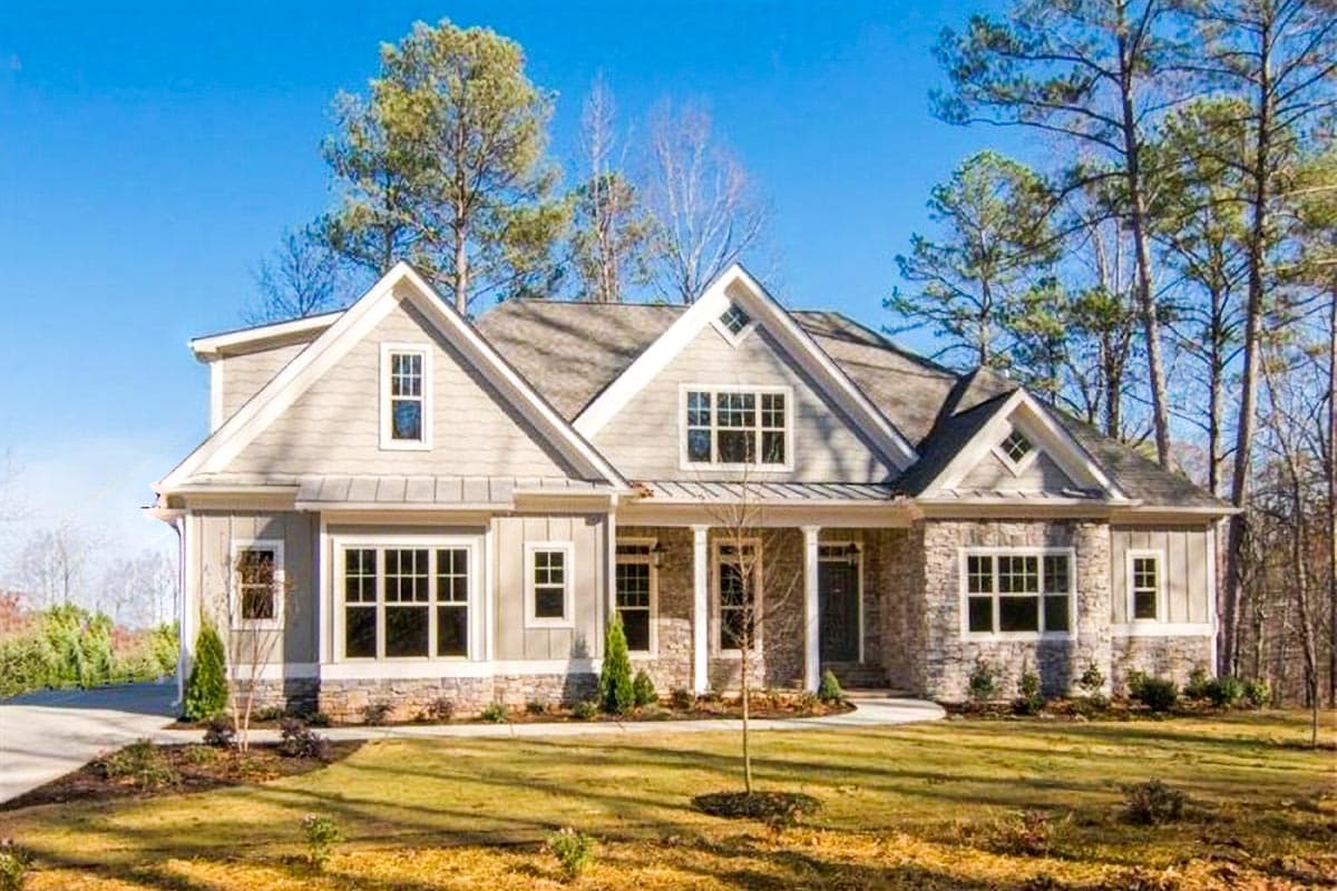 House plan exterior featuring a Craftsman style. The one-story home has multiple gables, a covered porch, and a combination of stone and siding.