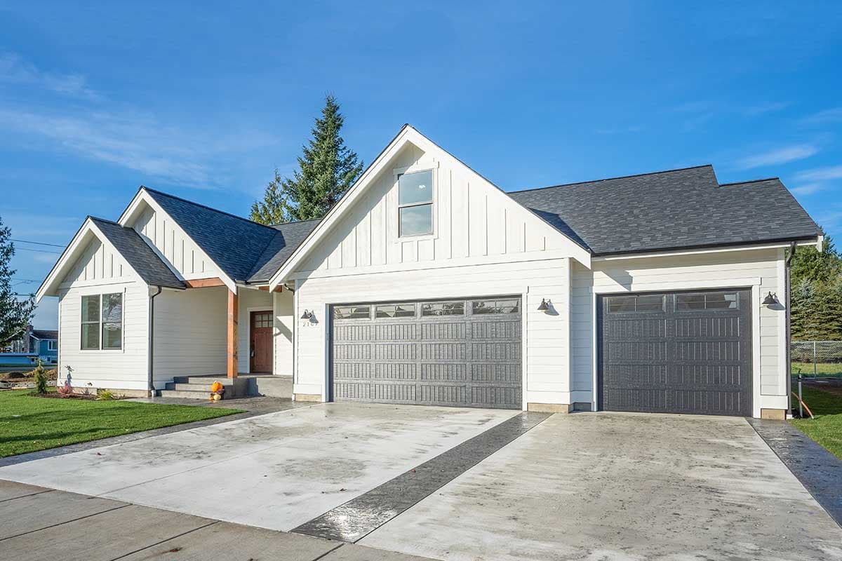 Modern Farmhouse style house plan exterior with two garages, gables, board-and-batten siding, and covered entry.