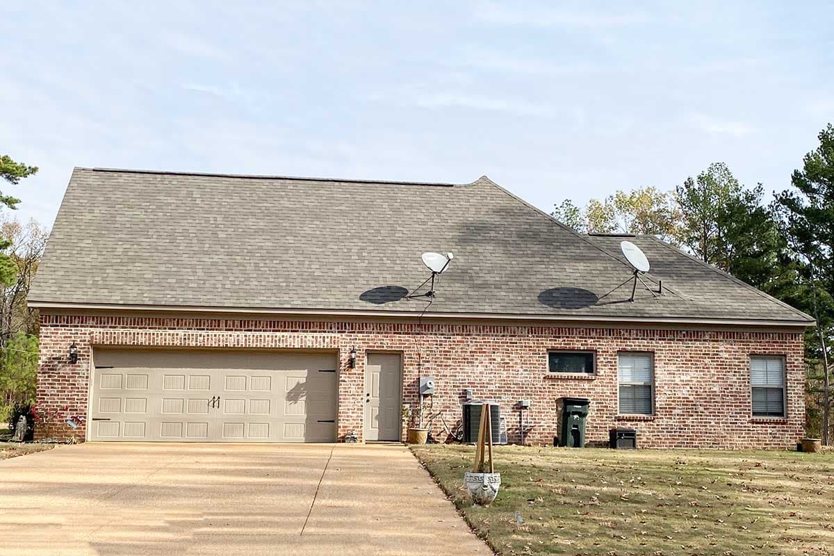 House plan exterior: one-story brick home with attached two-car garage, asphalt shingle roof, and asphalt driveway.