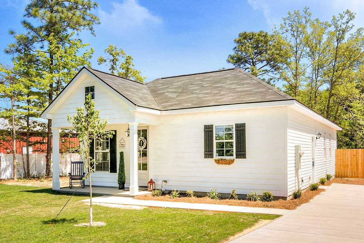 House plan exterior: Modern Farmhouse style, one story, with a covered front porch, gabled roof, and board-and-batten siding.