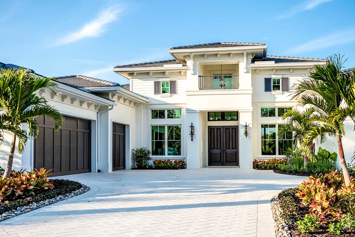 Two-story Modern house plan exterior with a two-car garage, balcony, and double front doors.