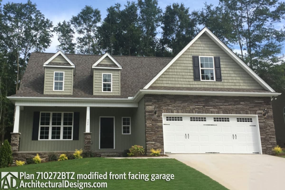 House plan exterior with dormers, stone base, covered porch, and front-facing two-car garage.