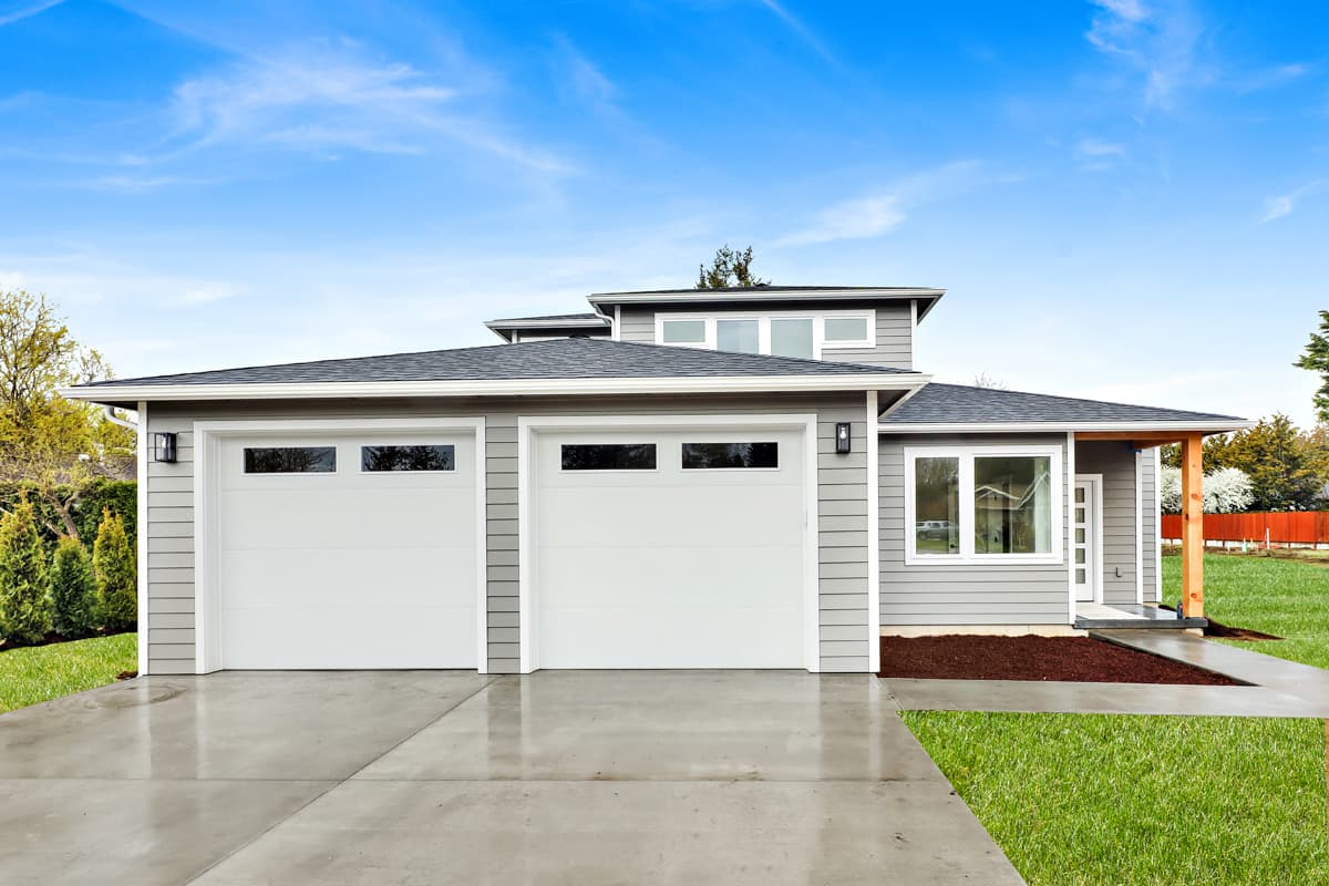 Modern house plan exterior with a two-car garage, horizontal siding, and a prominent covered entryway with wooden supports.