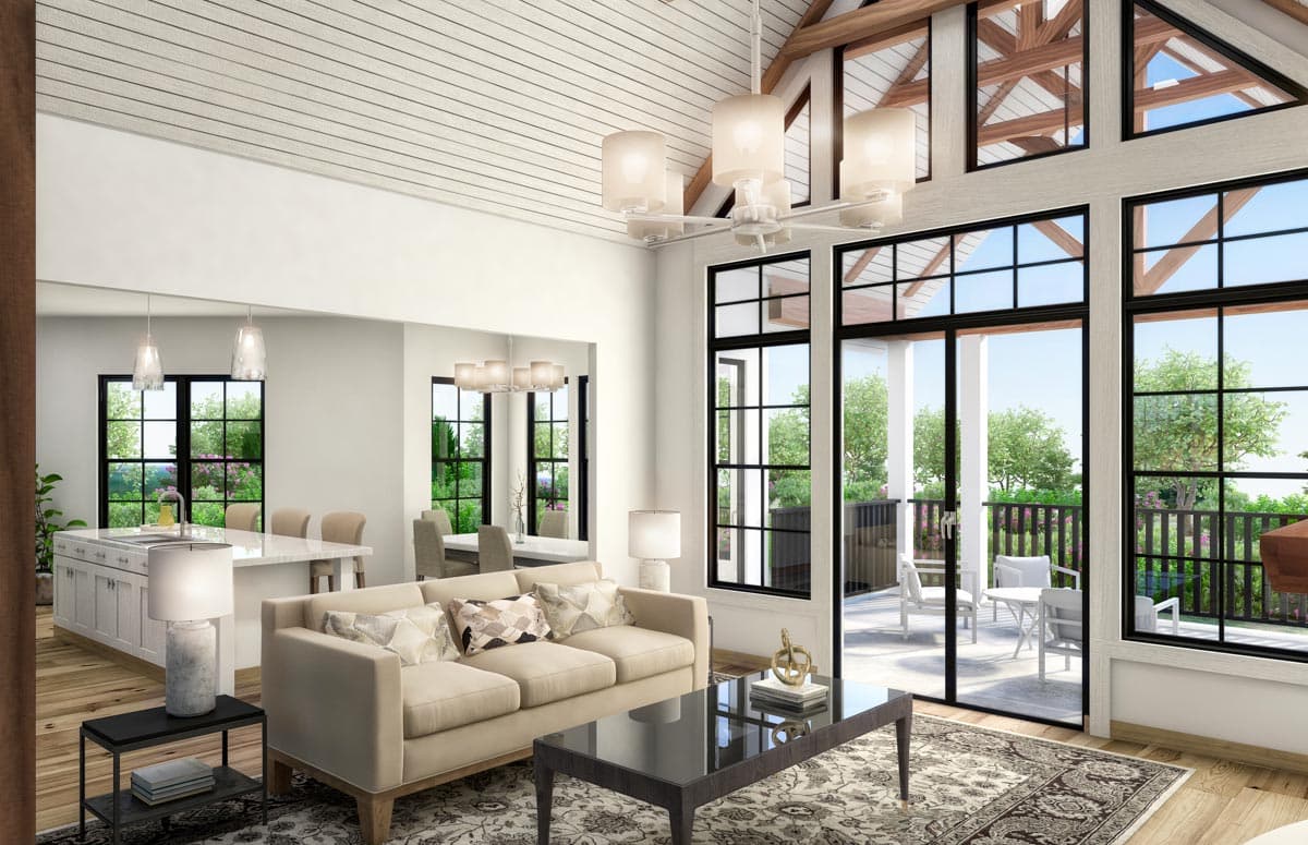 Open-concept living area with vaulted ceilings, fireplace, kitchen island, and large windows.