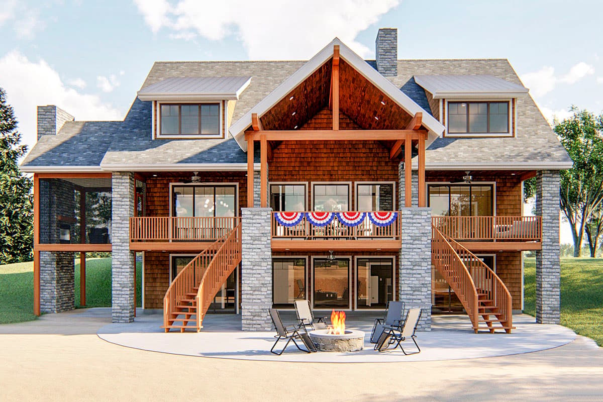 House plan exterior: A two-story home with stone accents, wood siding, a covered deck, and dual curved staircases.