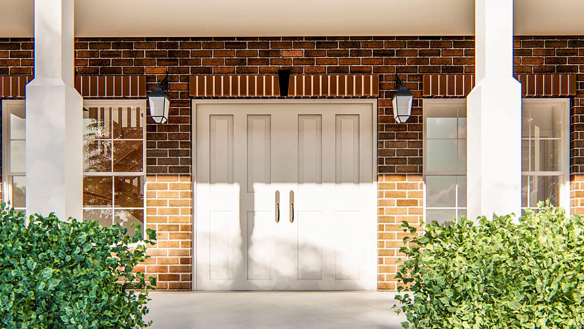 House plan exterior: double white doors flanked by windows, brick facade, and white columns supporting a porch.