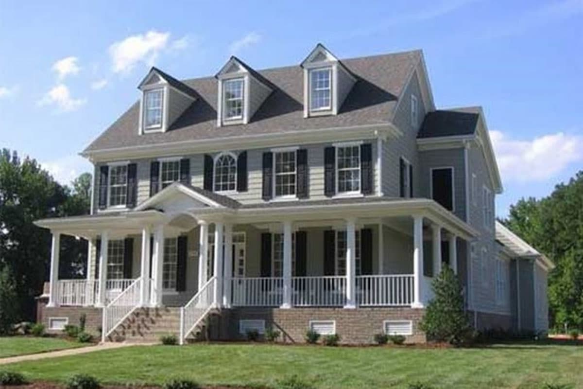 House plan exterior. Two-story Colonial with covered porch, dormers, and gabled roof. Features include shuttered windows and symmetrical facade.