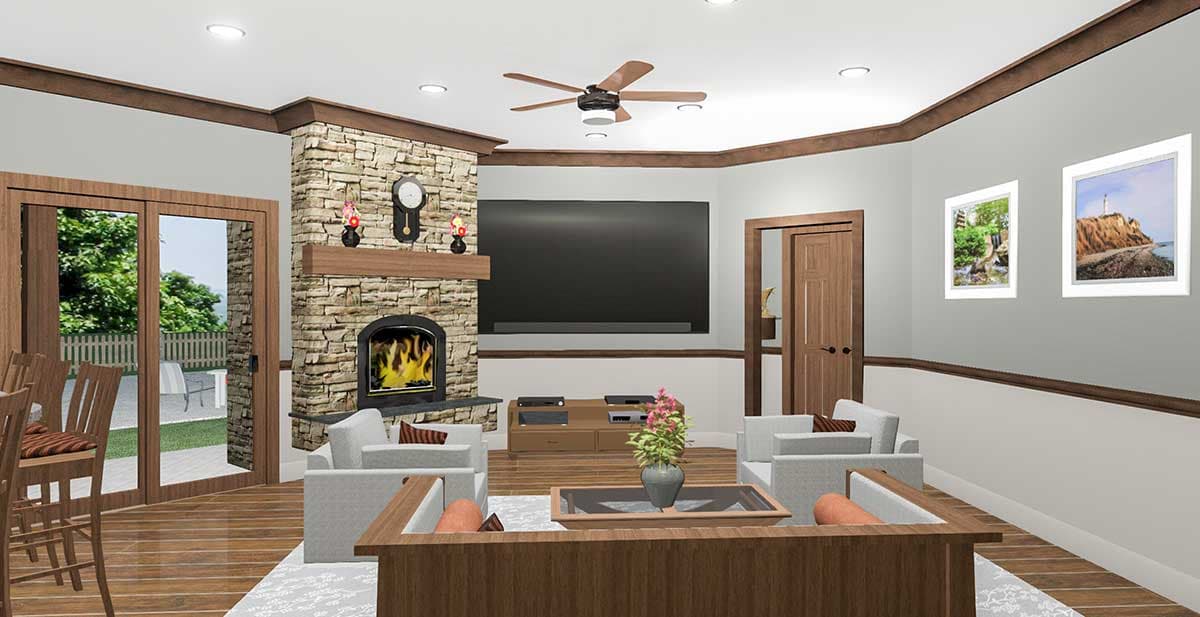 Living room with stone fireplace, television, ceiling fan, and sliding glass doors to an outdoor patio.