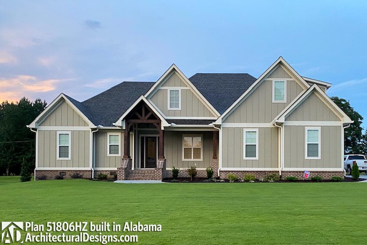 Exterior house plan featuring a prominent gable roofline, wood-accented covered entryway, and multiple gables.