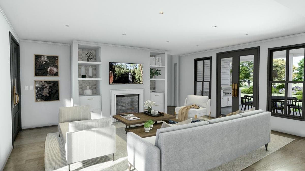 A modern living room with a fireplace, TV, and light gray furniture. Large windows offer a view of an outdoor patio.