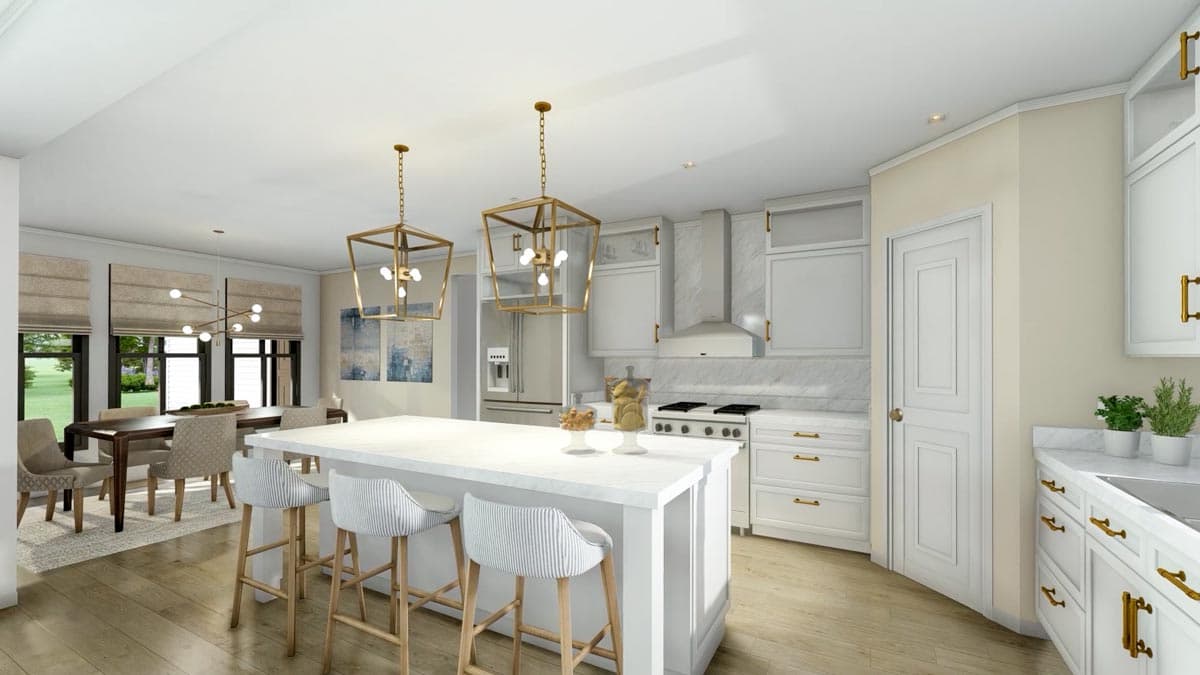 Spacious, modern kitchen with a large island, white cabinets, and gold accents. A dining area with a table and chairs is visible in the background.