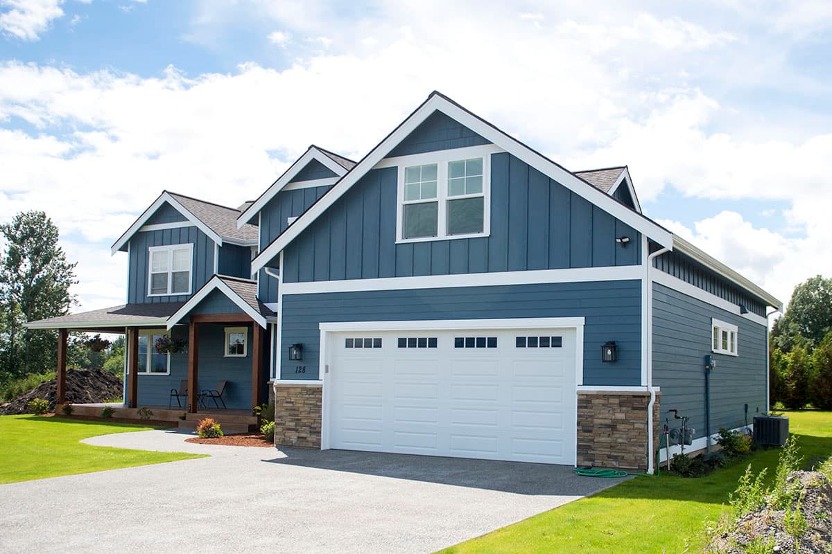 House plan exterior: two-story Modern Farmhouse with a side-entry garage, gables, and a covered front porch.