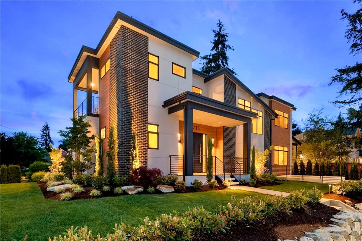 Modern house plan exterior with brick and wood siding, flat rooflines, covered entry porch, and balconies.