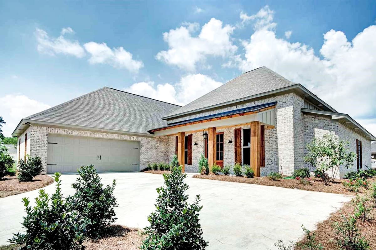 One-story house plan exterior with white brick, a side-facing garage, and a covered front porch with wooden columns and shutters.