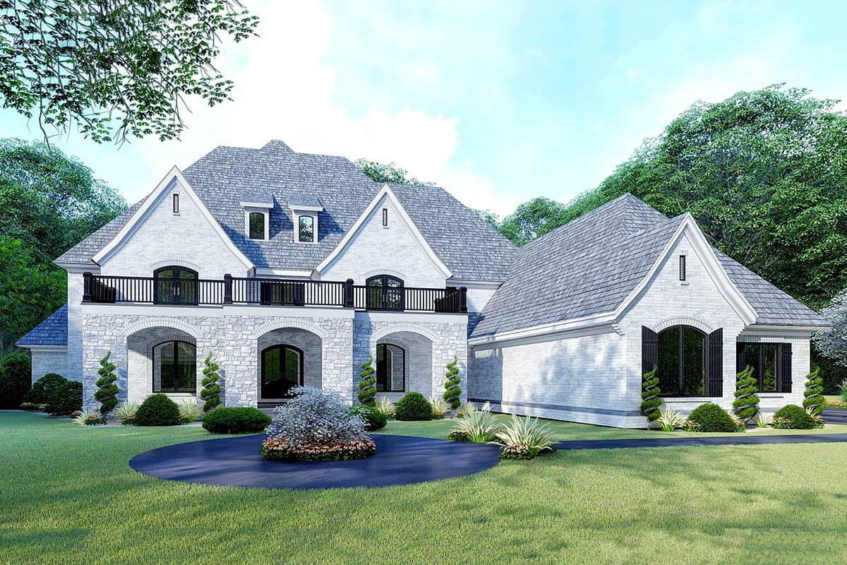 House plan exterior. Two-story home with a stone facade, arched entryways, gabled rooflines, dormers, and a balcony with black railing.