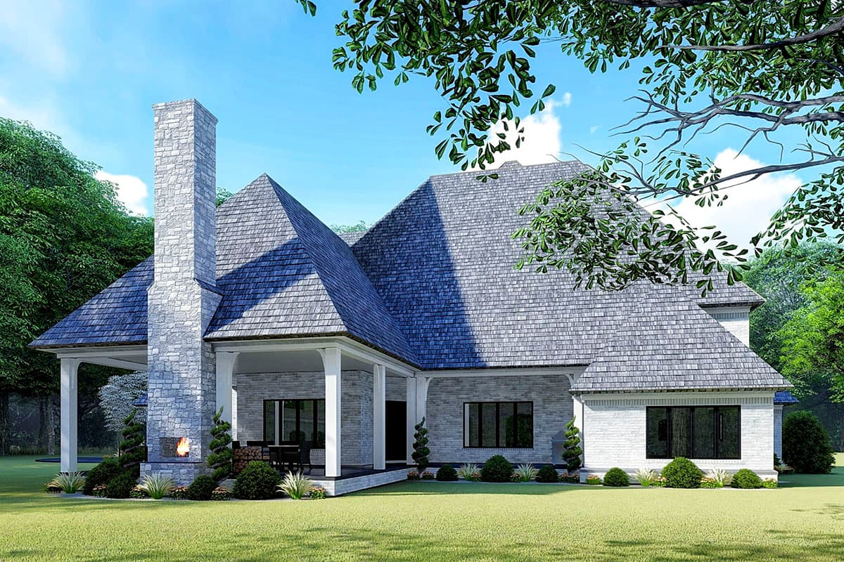 House plan exterior: A two-story home with a large stone chimney, covered porch with columns, and varied rooflines.