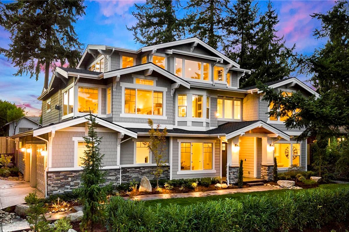 Craftsman style house plan exterior with multiple gables, dormers, stone accents, and a covered entry porch.