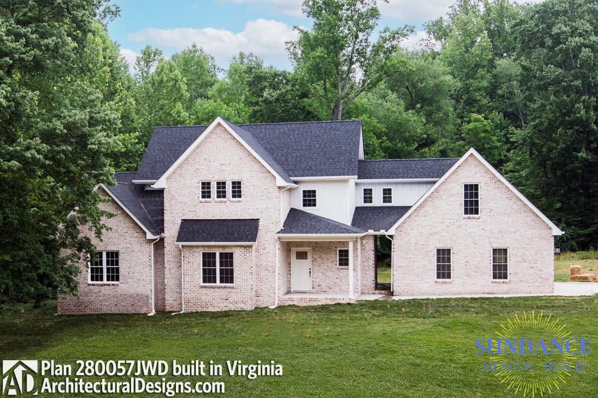 House plan exterior with white brick, multiple gables, dark roof, and covered entry.