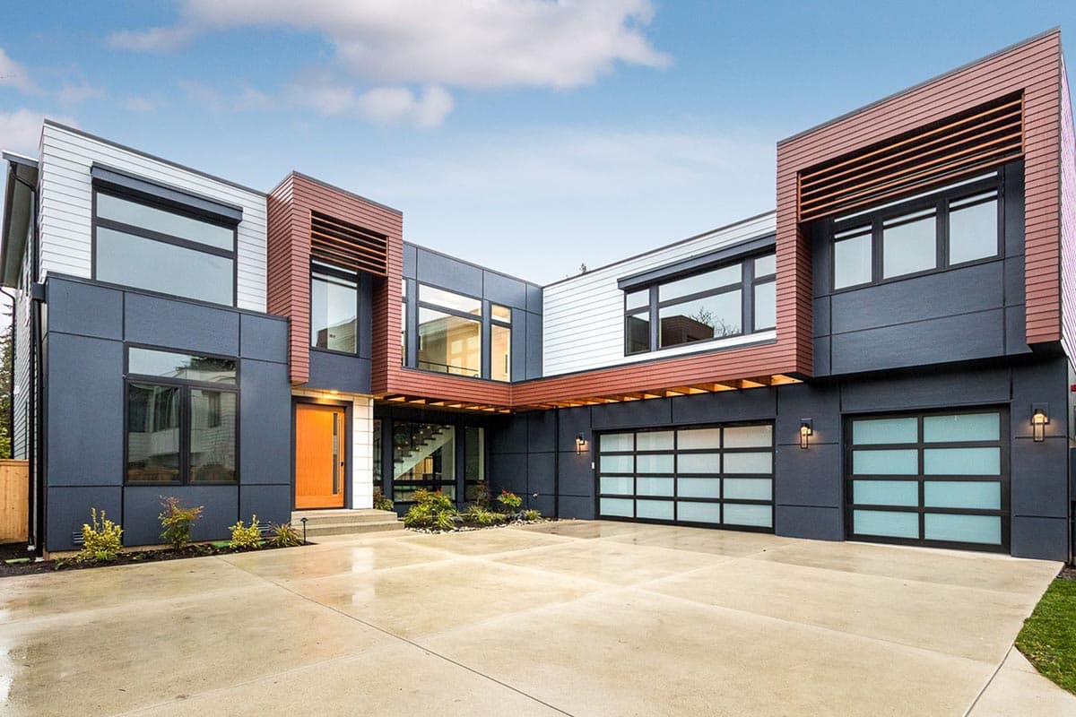 House plan exterior. Modern style with two stories, a two-car garage, and horizontal wood siding accents over the entryway and windows.