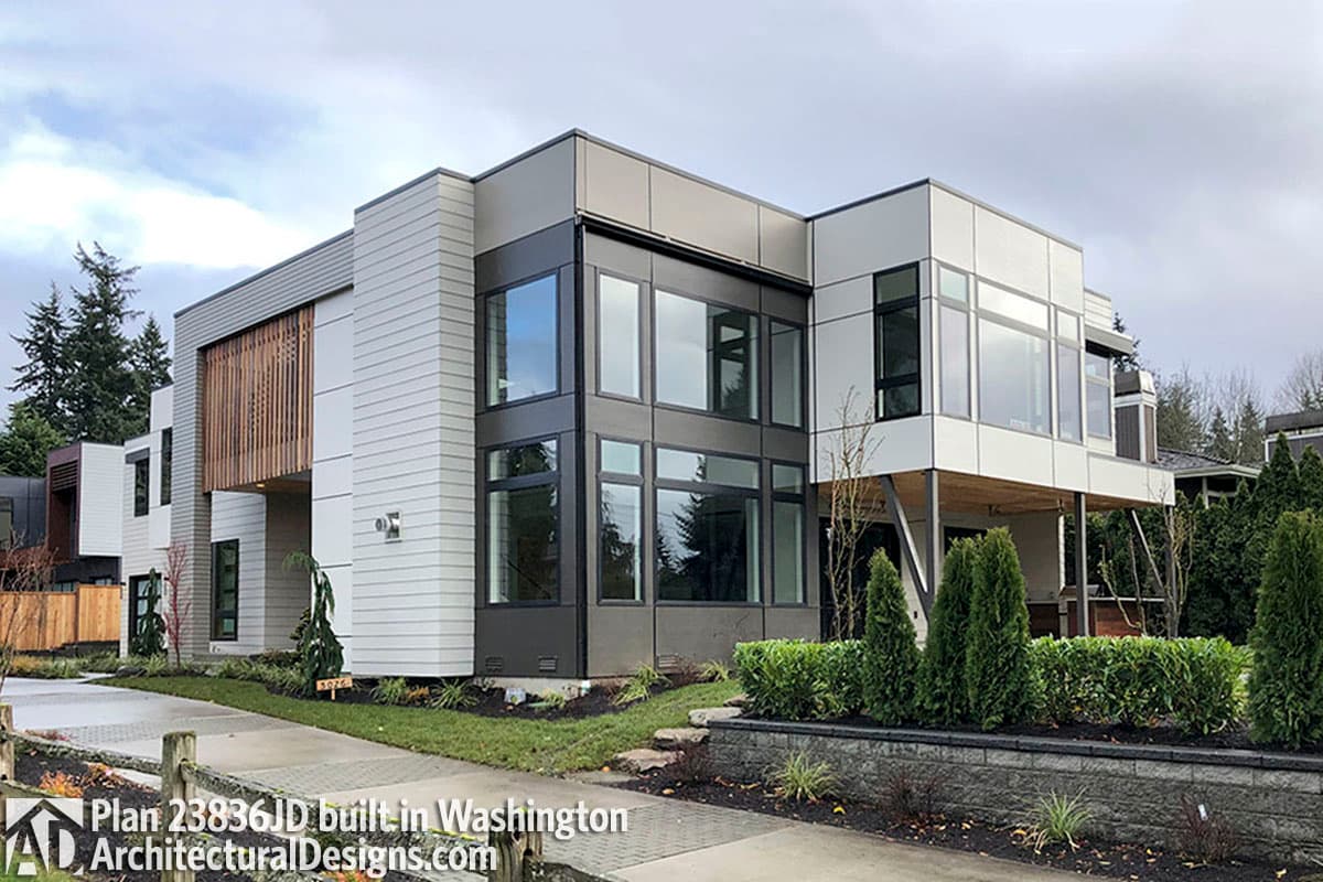 Modern house plan exterior with cantilevered sections, abundant glass, and vertical wood slat accent.