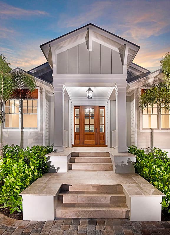 House plan exterior: Modern Farmhouse style, one story, double wood front doors, covered porch, stone steps.