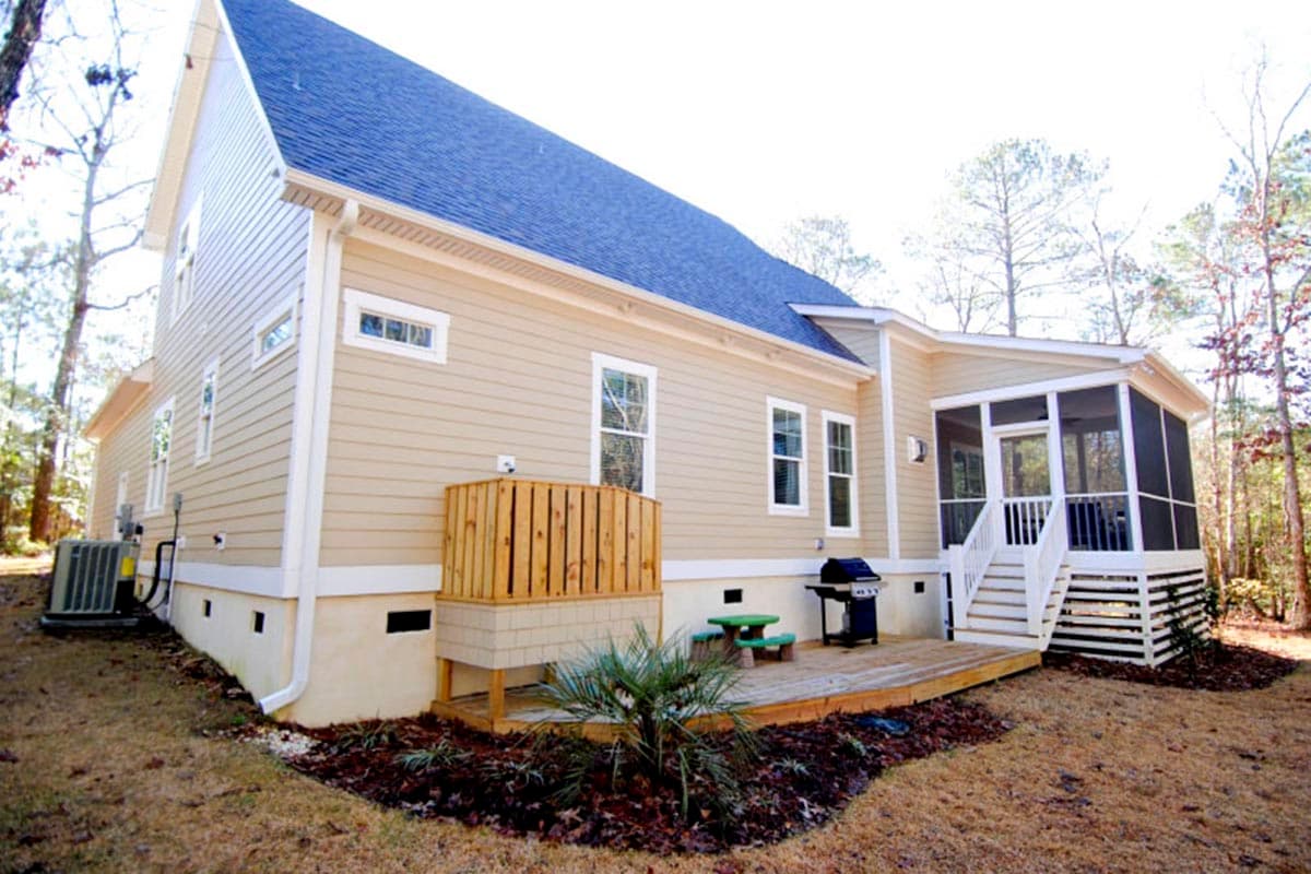 House plan exterior view of a beige two-story home with a screened-in porch, deck, and blue roof.