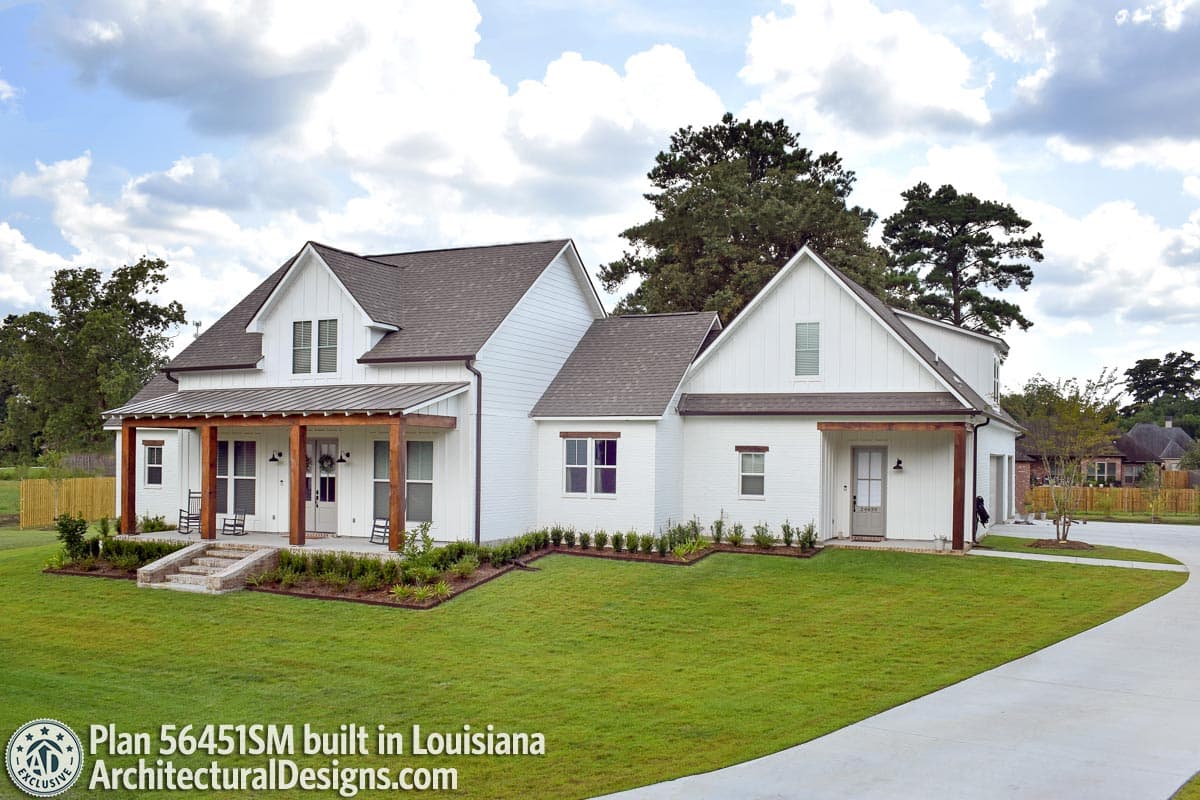 Modern Farmhouse house plan exterior with gabled dormers, covered front porch with wood posts, and horizontal siding.