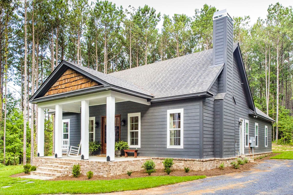 House plan exterior: Ranch style, one story, with a gabled entry porch, wood-shingled gable, and brick foundation.
