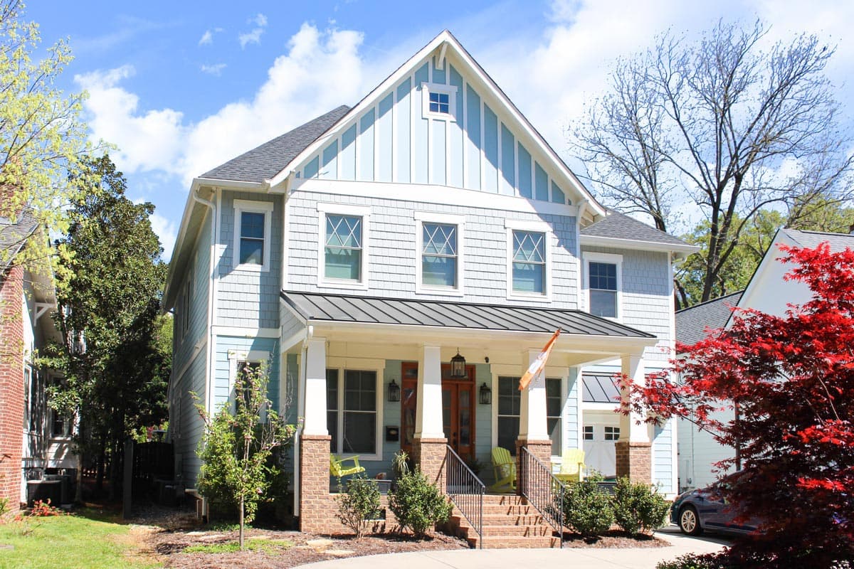 House plan exterior view, two-story Craftsman with front porch, gabled roof, and wood shingle siding.