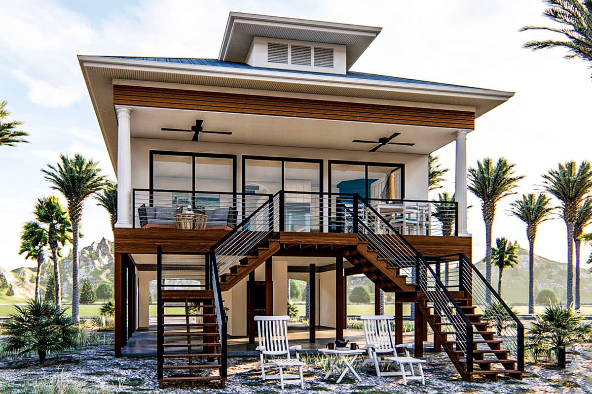 House plan exterior: two-story elevated home with wide stairs, large windows, wrap-around deck, and pitched roof.