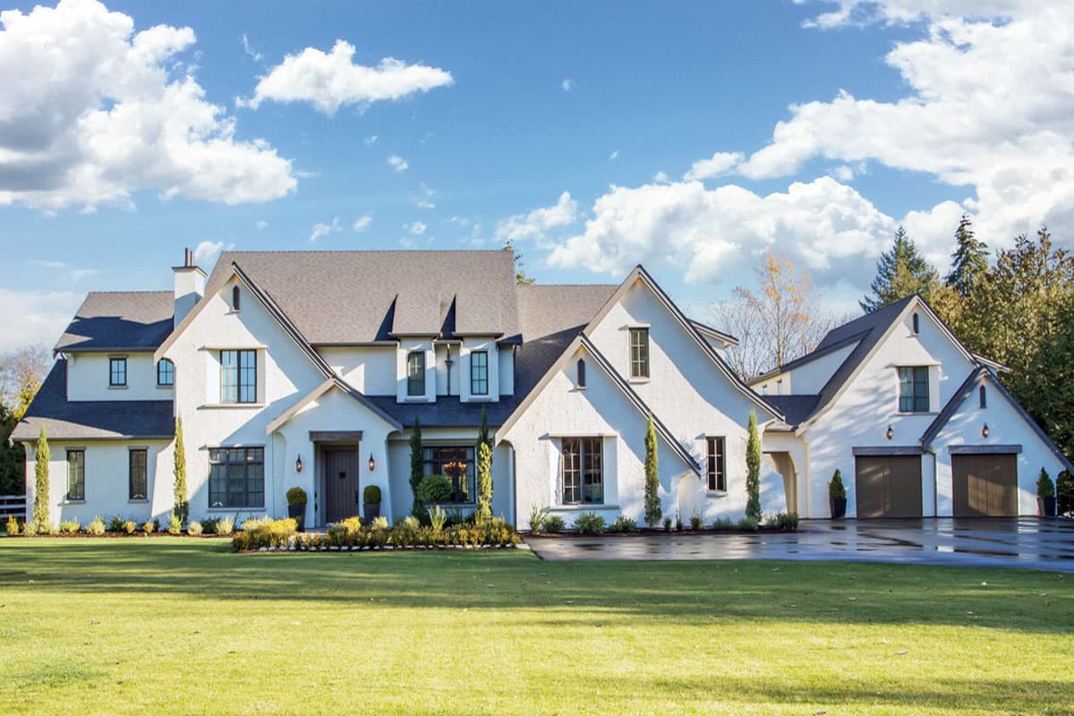 House plan exterior. Two-story Modern house with multiple gables, dormers, and a detached garage with two bays. Features symmetrical design.