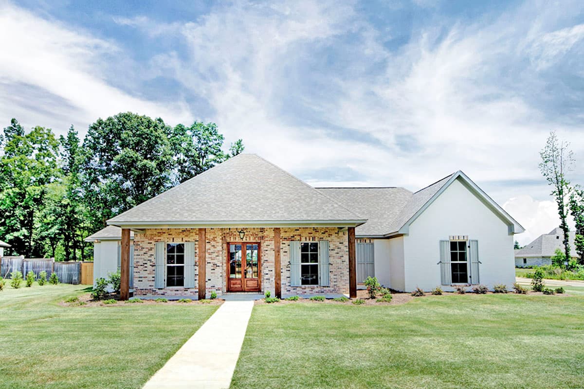 House plan exterior. One-story house with brick and white siding. Features include a front porch with wood columns and a gabled roofline.