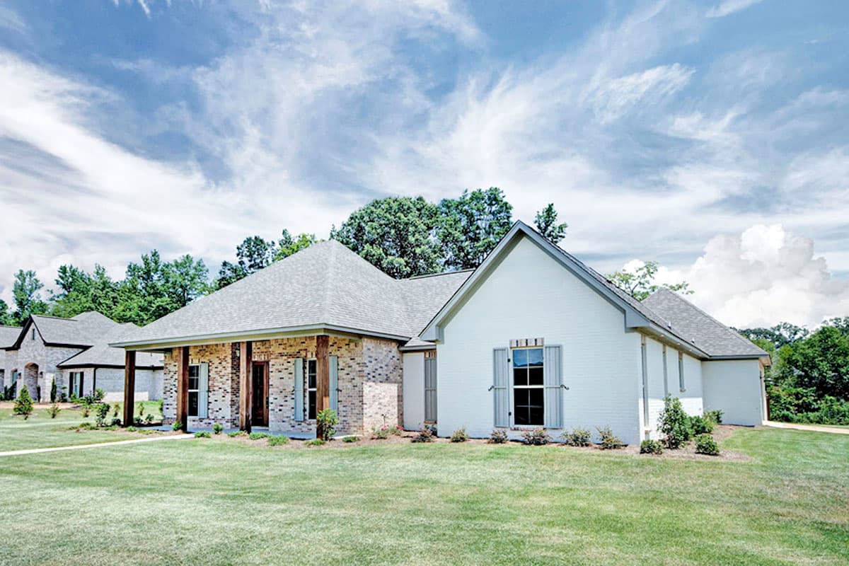 House plan exterior: One-story home with brick and white siding, gabled roof, and covered front porch with wood columns.