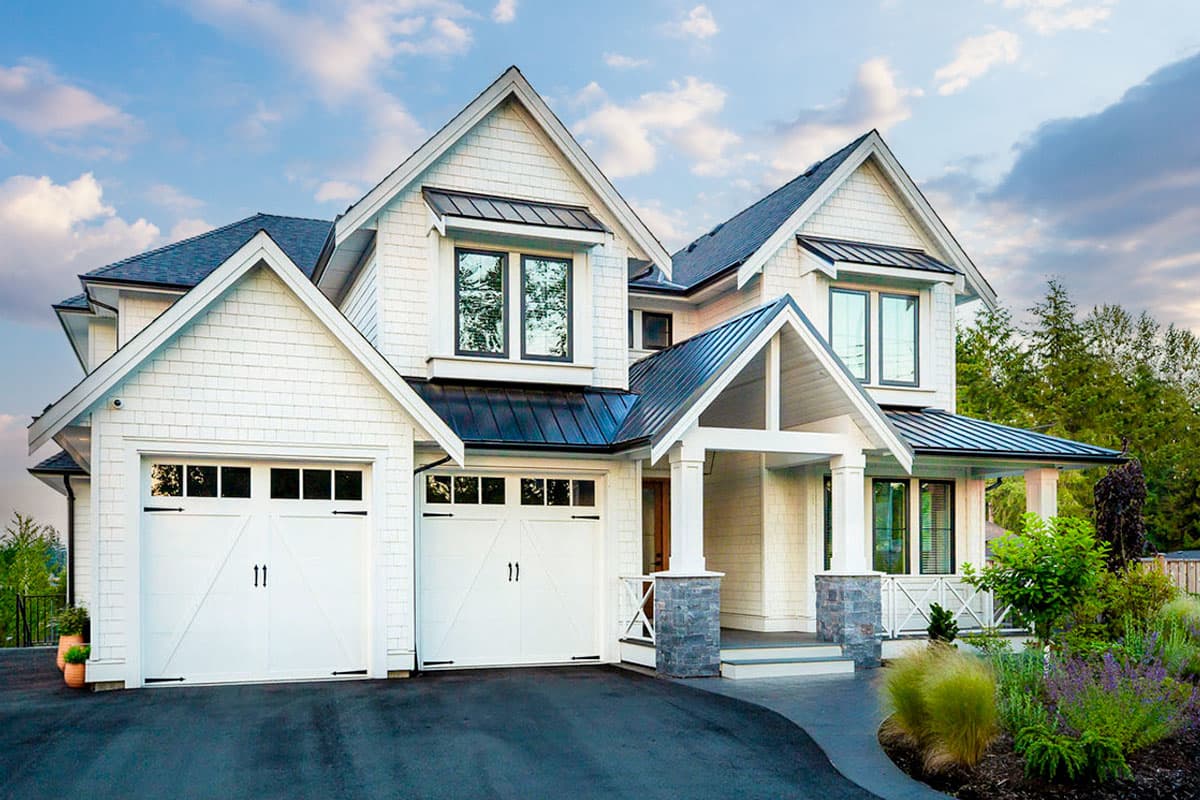 House plan exterior rendering. Two-story Craftsman style home with gabled roof, covered porch, and attached garage. Exterior features shingle siding.